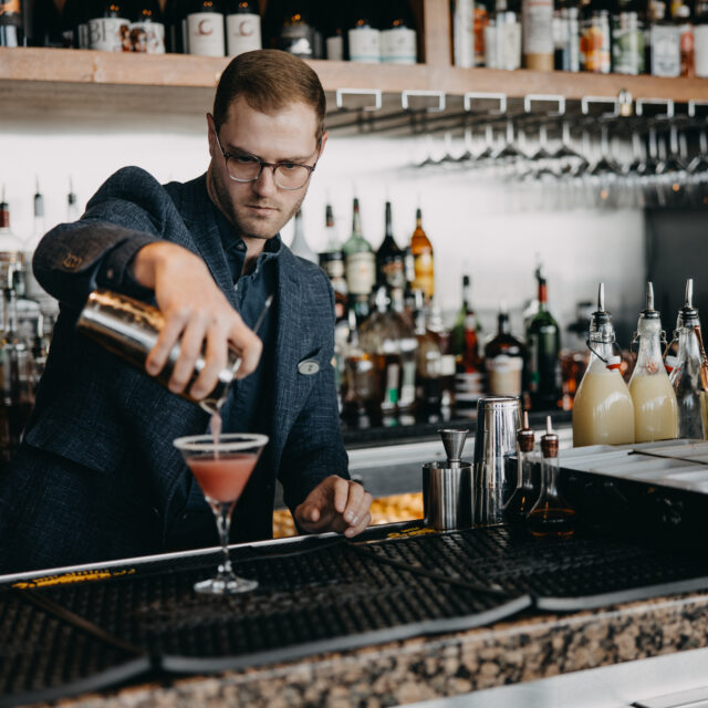 Bartender pours cocktail