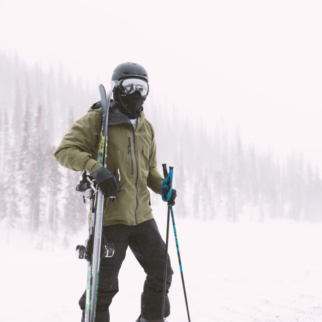 Man walking with skis on mountain